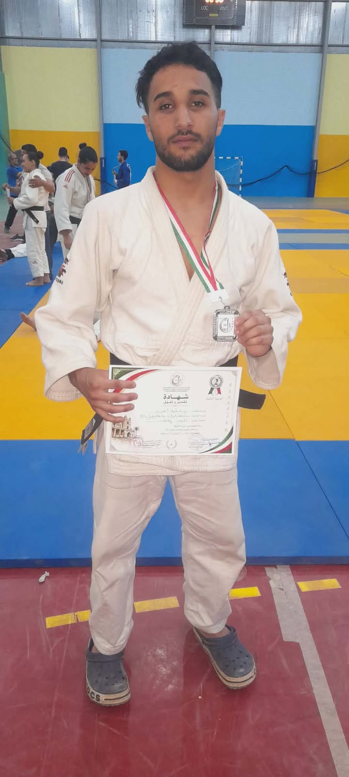 Ben Attia Ahmed from the Faculty of Humanities, after winning the silver medal in the final in Algeria in the weight category (-67) kg, specializing in the sport of judo.
